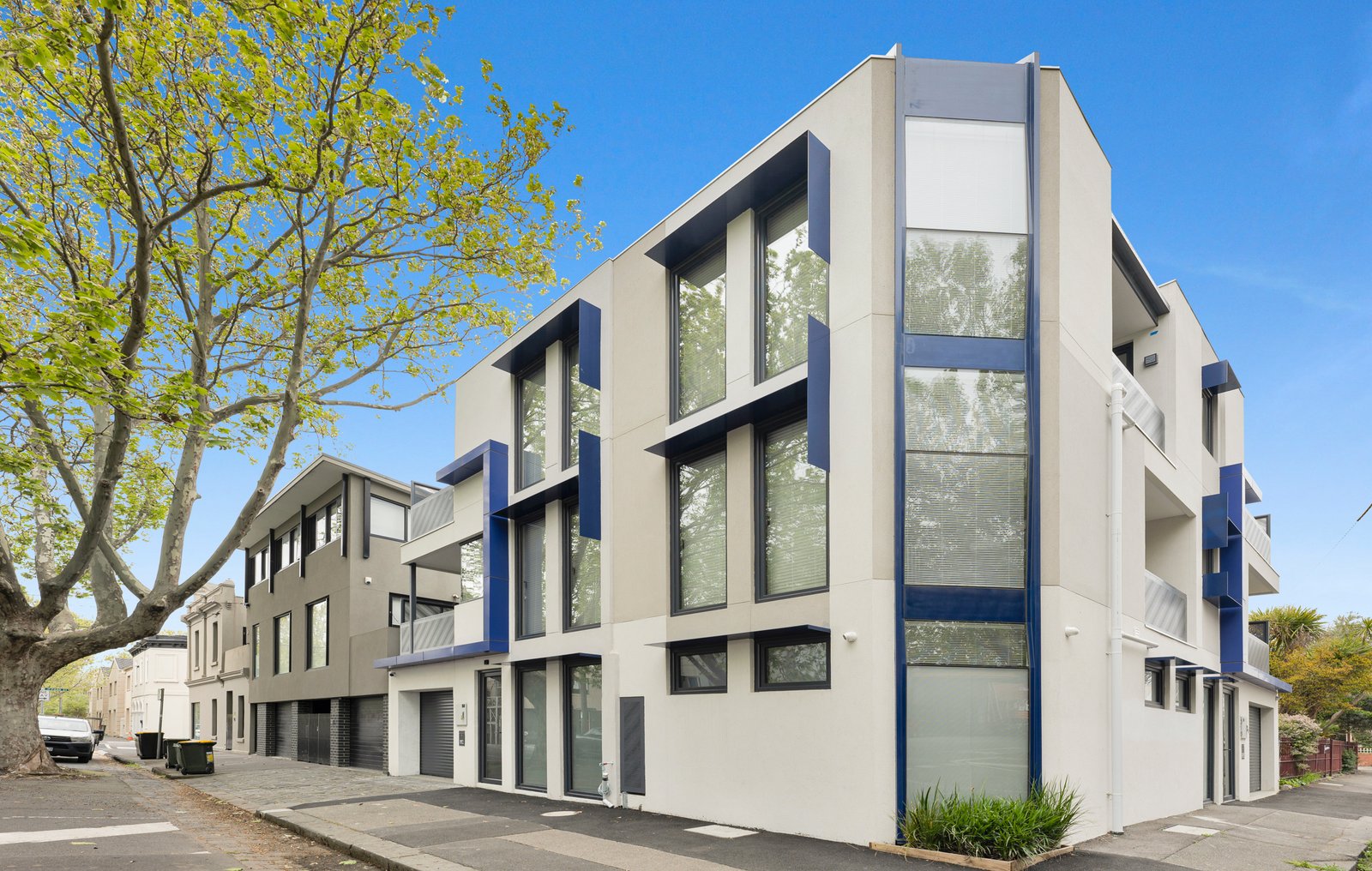 Top-floor entertaining terrace with views across the tree canopy to the Carringbush Hotel