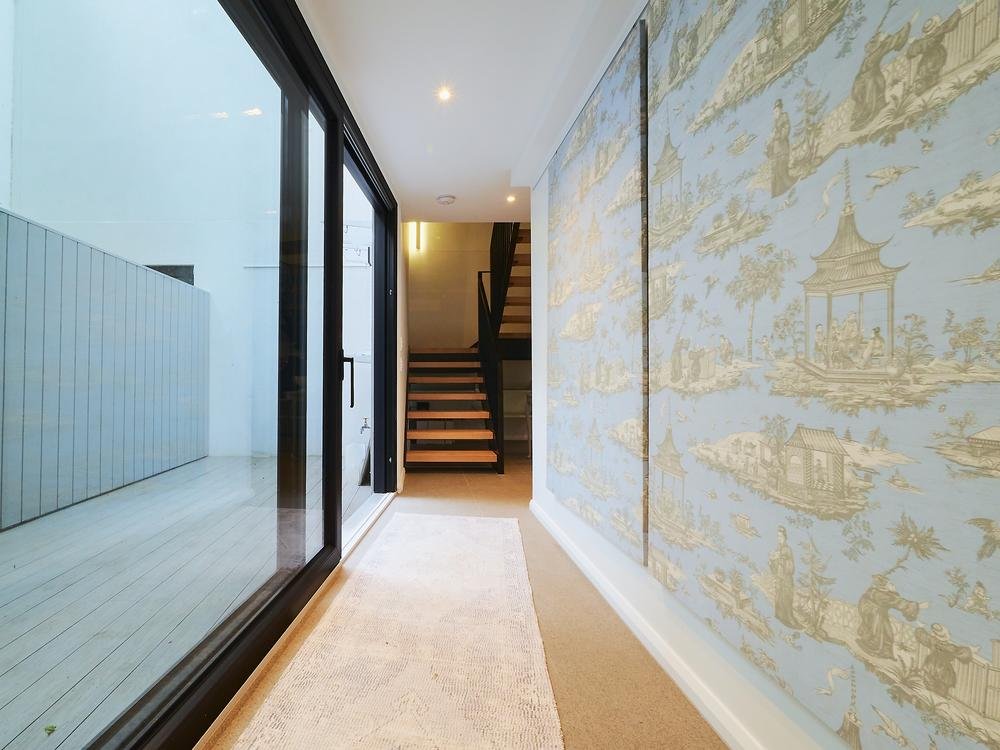Ground floor hallway with chinoiserie doors and courtyard